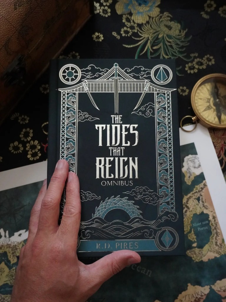 Hardcover edition of The Tides That Reign epic fantasy saga omnibus, featuring a teal cover with a silver foiled image of a sea serpent cresting waves.